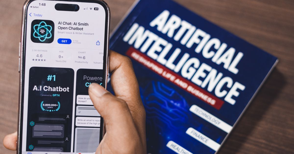 Cómo usar asistentes de IA para comparar compras sin delegar tus decisiones importantes tecnología moderna: Smartphone displaying AI app with book on AI technology in background.
