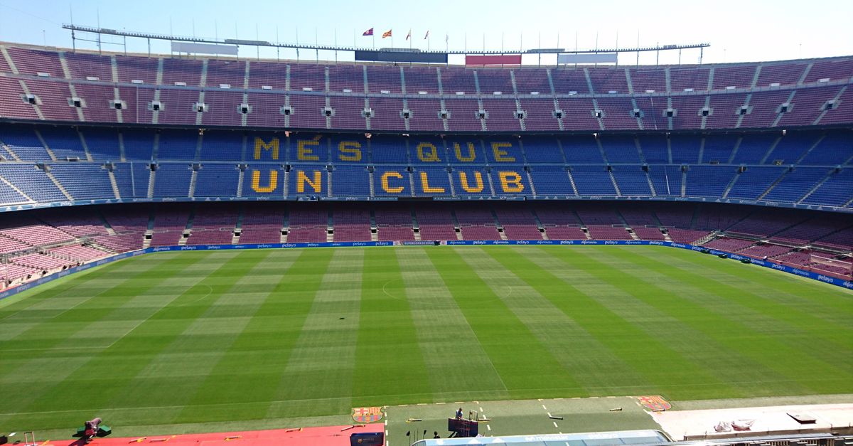 Panoramic view of Camp Nou stadium in Barcelona, home of FC Barcelona football team, with 'Mes Que Un Club' slogan.